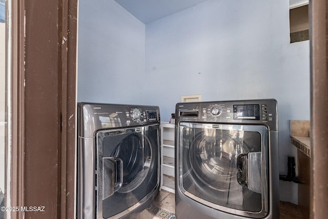 laundry room featuring laundry area, tile patterned flooring, and washing machine and clothes dryer