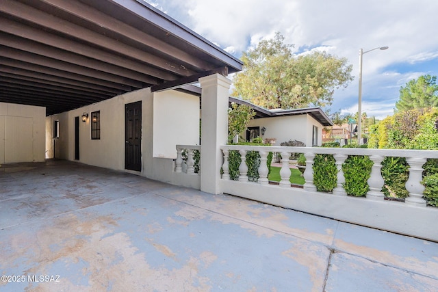 view of side of home with stucco siding