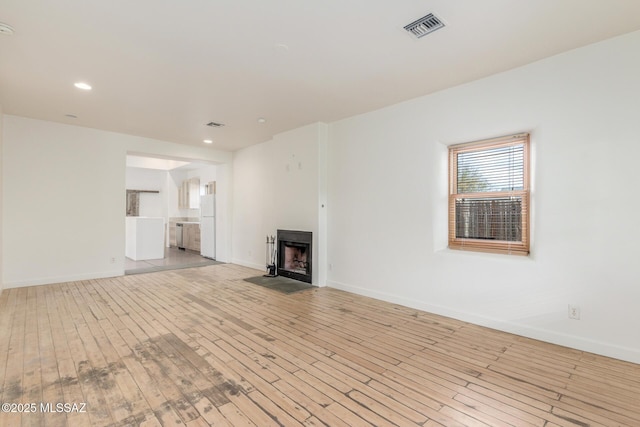 unfurnished living room with light hardwood / wood-style flooring