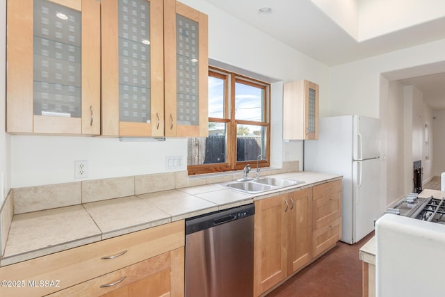 kitchen featuring white refrigerator, sink, stainless steel dishwasher, and light brown cabinets