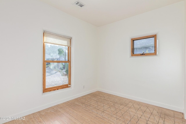 unfurnished room with light hardwood / wood-style flooring