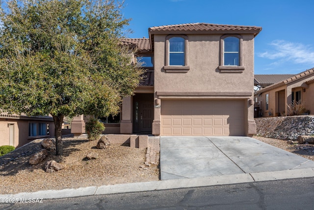 view of front facade featuring stucco siding, a tiled roof, concrete driveway, and a garage