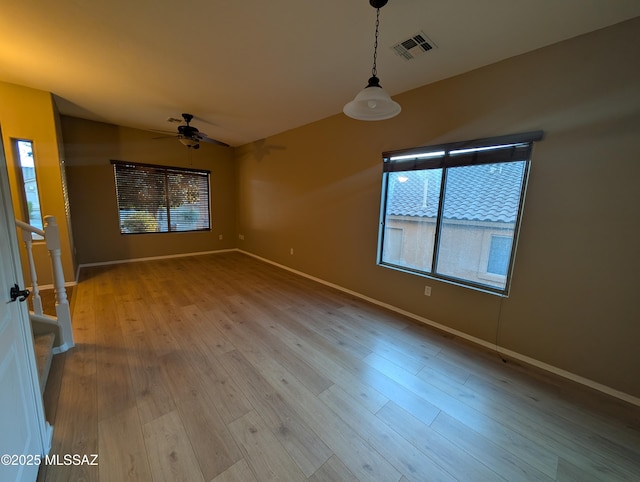 empty room featuring lofted ceiling, light hardwood / wood-style floors, and ceiling fan