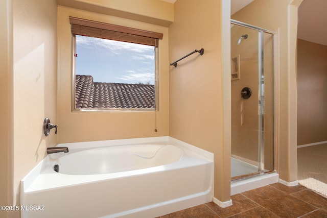 bathroom featuring a stall shower and a bath