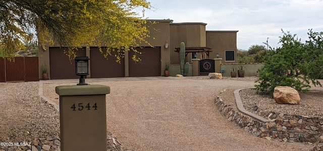 pueblo-style house featuring a garage