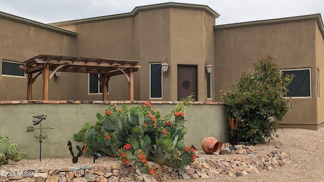 view of home's exterior with a pergola