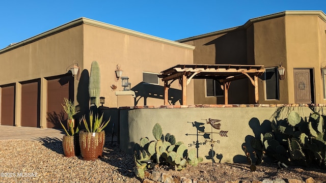 view of side of property with a pergola and a garage