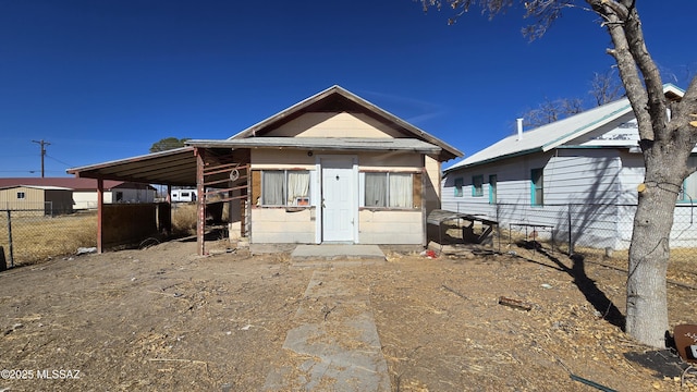 view of front of house with a carport and an outdoor structure