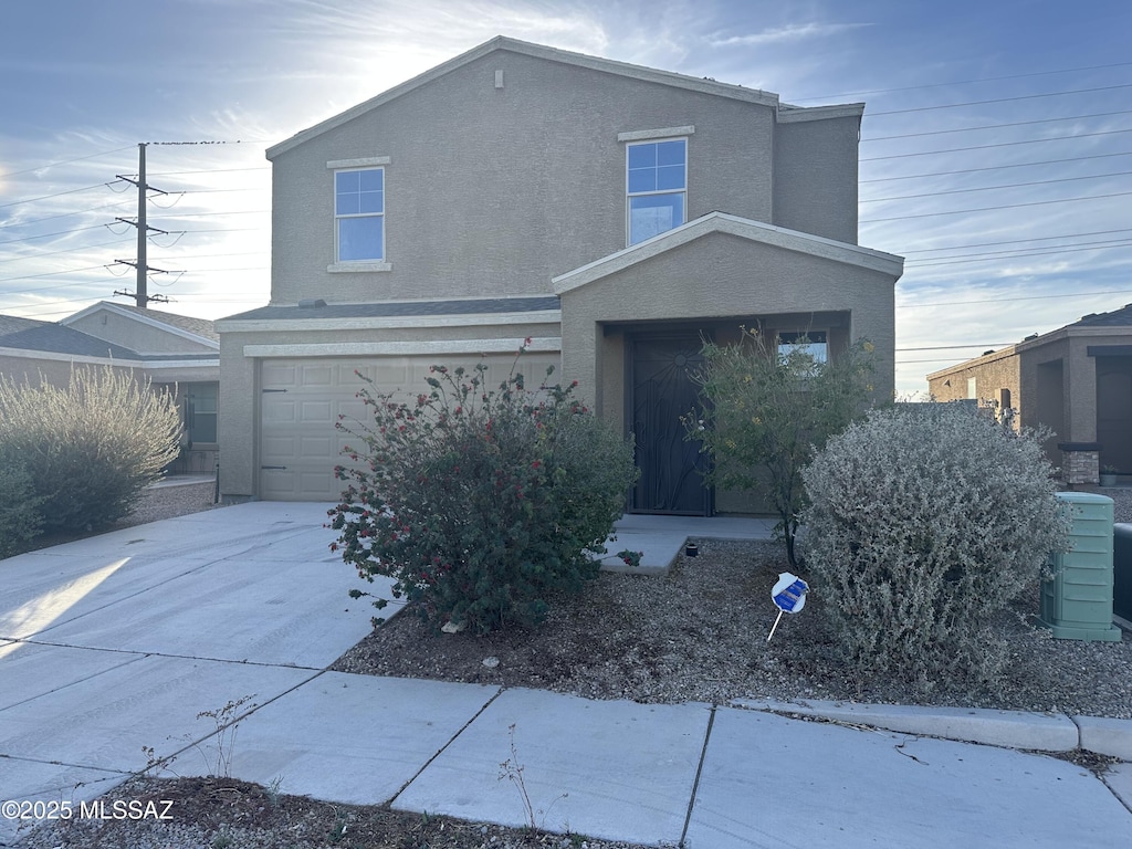 view of front of property with central AC and a garage