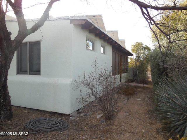 view of side of property with stucco siding