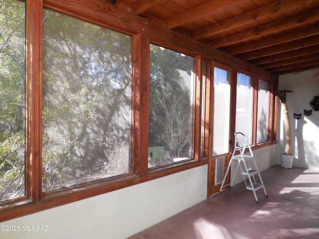 unfurnished sunroom with wood ceiling and beam ceiling