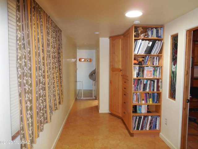 hallway featuring baseboards