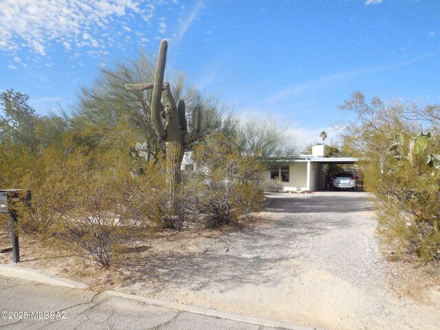 obstructed view of property with a carport and driveway