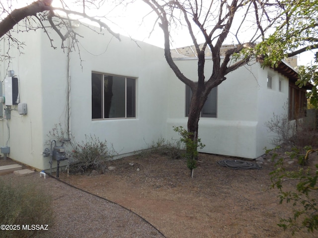 view of side of property featuring stucco siding