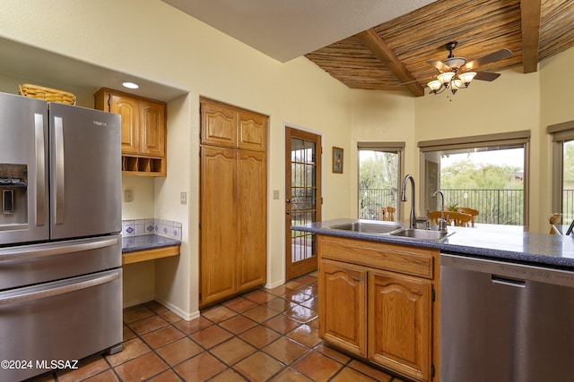 kitchen featuring sink, ceiling fan, appliances with stainless steel finishes, tile patterned flooring, and beam ceiling