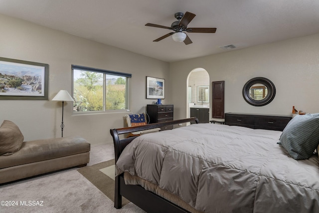 bedroom featuring ensuite bath, carpet floors, and ceiling fan