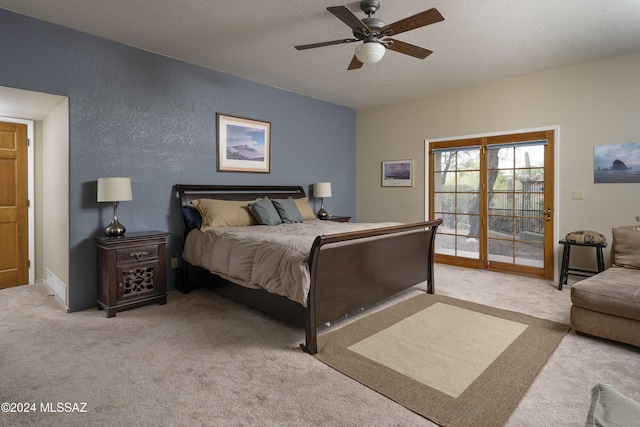 carpeted bedroom with ceiling fan, a textured ceiling, and access to outside