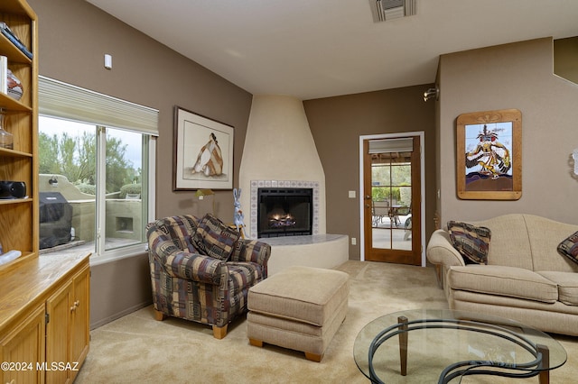 carpeted living room with a fireplace