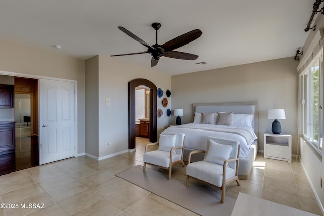 tiled bedroom featuring ceiling fan