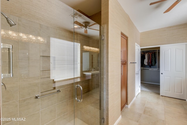 bathroom featuring tile patterned flooring, ceiling fan, and a shower with shower door