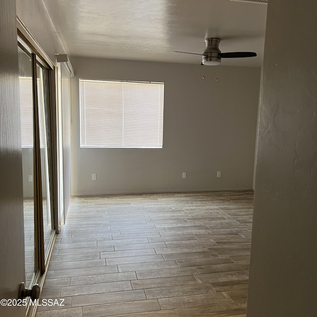 unfurnished room with ceiling fan and wood finished floors