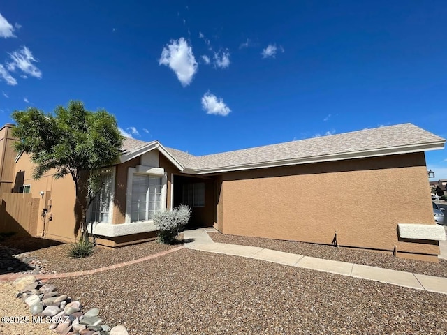 ranch-style home featuring stucco siding