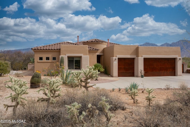 view of front of home featuring a garage and a mountain view