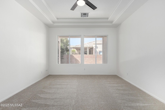 unfurnished room with carpet floors, ceiling fan, and a raised ceiling