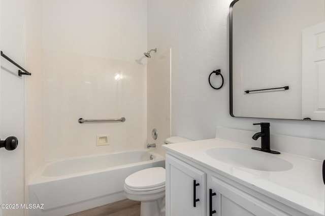 full bathroom with hardwood / wood-style flooring, toilet, vanity, and shower / washtub combination