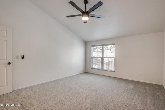 carpeted empty room featuring ceiling fan and vaulted ceiling