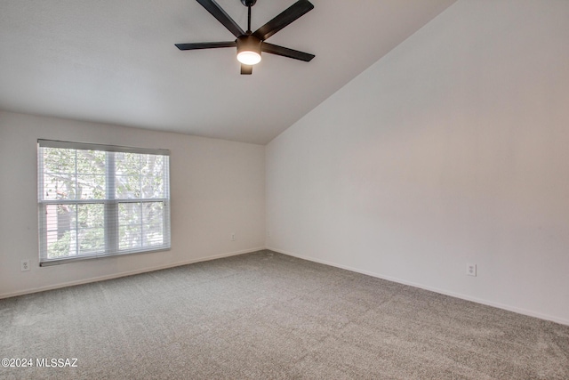 spare room featuring ceiling fan, lofted ceiling, and carpet flooring