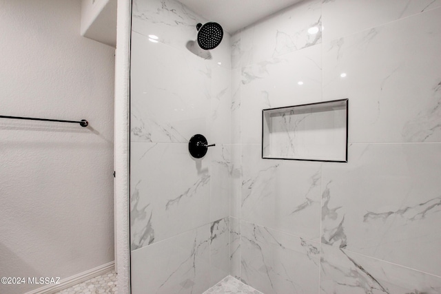 bathroom with tiled shower