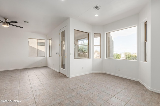 spare room featuring ceiling fan and light tile patterned floors