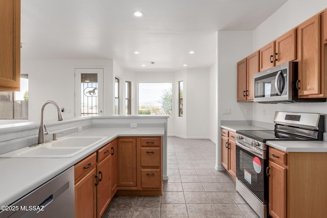 kitchen featuring sink, plenty of natural light, light tile patterned flooring, and appliances with stainless steel finishes