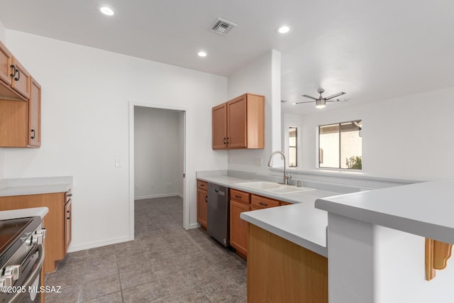 kitchen featuring appliances with stainless steel finishes, sink, light tile patterned floors, ceiling fan, and kitchen peninsula