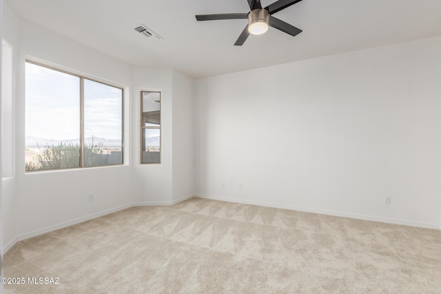 spare room with light carpet and ceiling fan