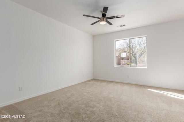 unfurnished room featuring light carpet and ceiling fan