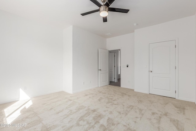 unfurnished bedroom featuring light carpet and ceiling fan