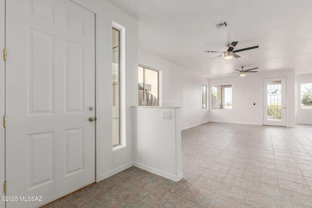 foyer entrance featuring light tile patterned floors and ceiling fan