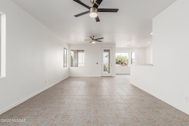 unfurnished living room with light tile patterned floors and ceiling fan