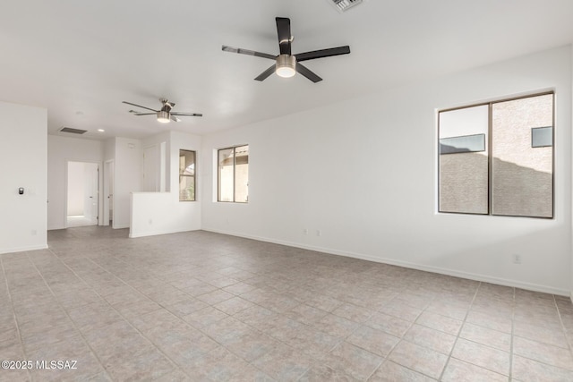 empty room featuring ceiling fan and light tile patterned flooring