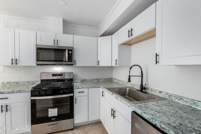 kitchen with sink, stainless steel appliances, and white cabinets