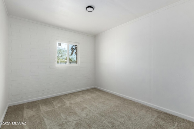 unfurnished room featuring crown molding, brick wall, and light carpet