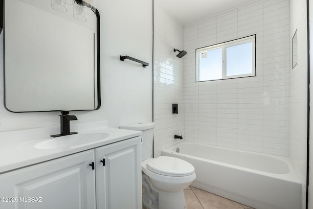 full bathroom with tile patterned floors, toilet, tiled shower / bath combo, and vanity