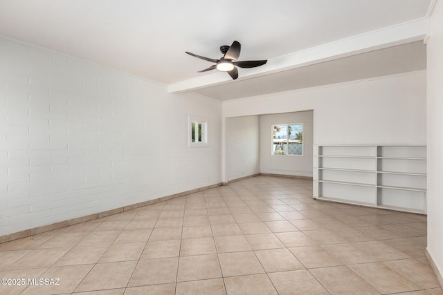 unfurnished room with beam ceiling, brick wall, light tile patterned floors, and ceiling fan