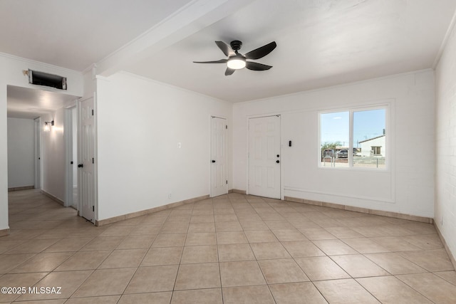 tiled empty room featuring ornamental molding and ceiling fan