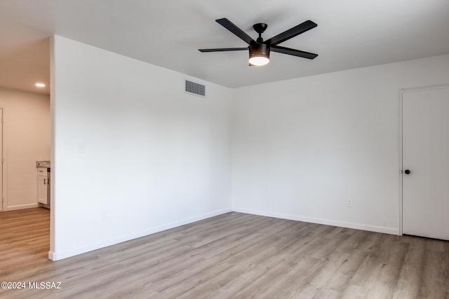 unfurnished room featuring ceiling fan and light hardwood / wood-style floors