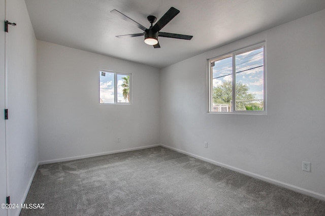 empty room with ceiling fan and carpet flooring