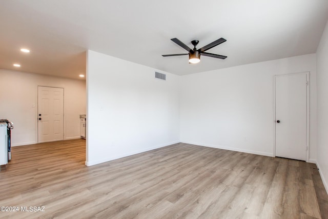 empty room featuring light hardwood / wood-style flooring and ceiling fan