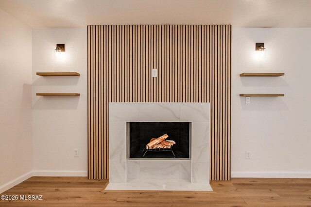 kitchen featuring appliances with stainless steel finishes, sink, light hardwood / wood-style flooring, and backsplash